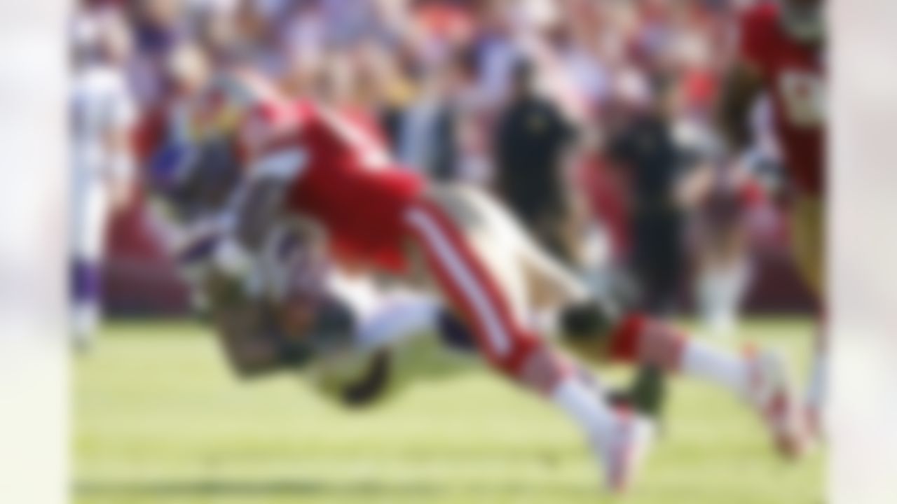 San Francisco 49ers linebacker Manny Lawson sends Minnesota Vikings running back Chester Taylor flying after a reception as the 49errs led at the half 6 to 3 at Monster Park in San Francisco, California on November 5, 2006. Photo by Getty Images.