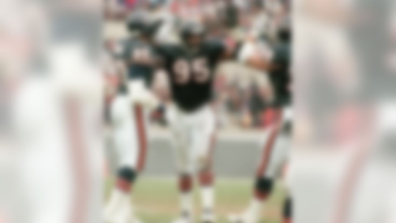 Chicago Bears' Richard Dent, center, celebrates after a play with teammates Alonzo Spellman, left, and Tim Ryan during an NFL football game against the Green Bay Packers in Chicago on December 5, 1993. Dent will finally become the third member of the legendary 1985 Chicago Bears defense to be inducted into the Hall of Fame on Saturday, Aug. 6, 2011, when he joins fellow "Monsters of the Midway" Dan Hampton and Mike Singletary, an honor that his teammates and coaches say is long overdue. (AP Photo/David Boe)