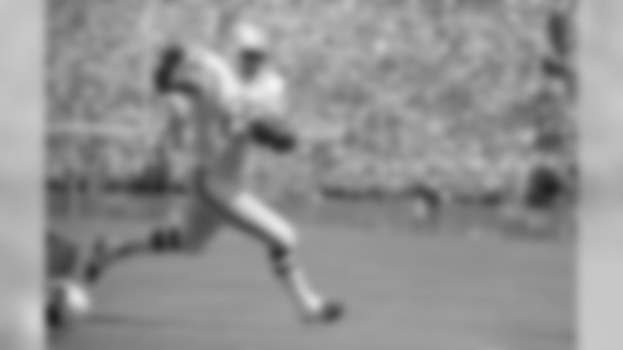Miami Dolphins running back Eugene "Mercury" Morris runs with the ball toward the end zone on Sunday, Nov. 13, 1972 for a score against the New England Patriots, 52-0 to give coach Don Shula his 100th victory in ten years in the NFL. The game was played in Miami's orange Bowl. (AP Photo/Jim Bourdier)