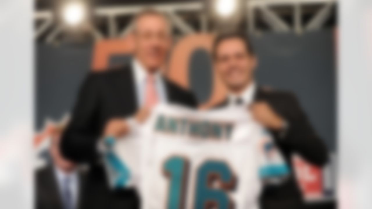 Stephen M. Ross, left, owner and managing general partner of the Miami Dolphins, presents Marc Anthony a Miami Dolphins jersey during a news conference announcing his minority ownership in the team Tuesday, July 21, 2009 in New York. (AP Photo/Evan Agostini)