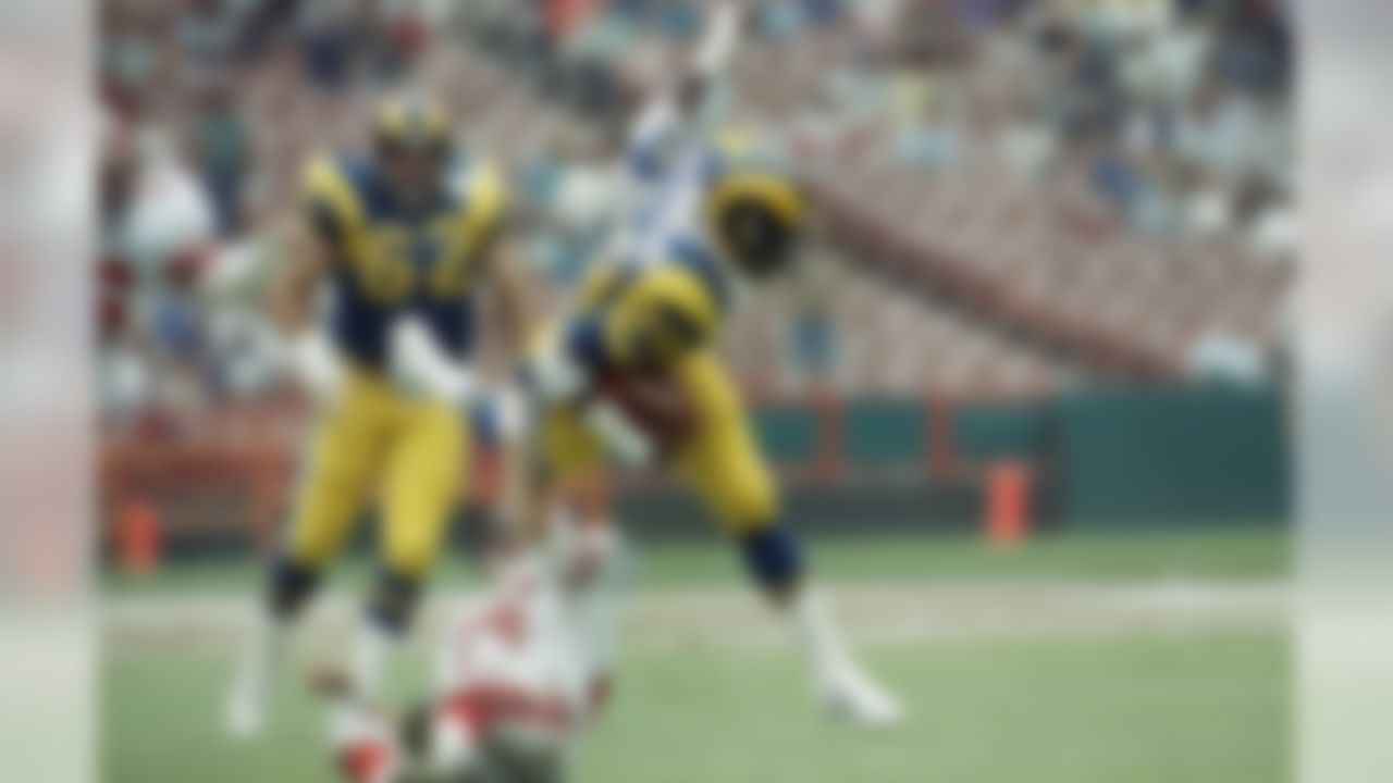 Los Angeles Rams running back Eric Dickerson is stopped by Atlanta Falcons safety Scott Case during first quarter of NFL Game at Anaheim Stadium on Sunday, Sept. 29, 1985 in Anaheim, California. (AP Photo/Steve Dykes)