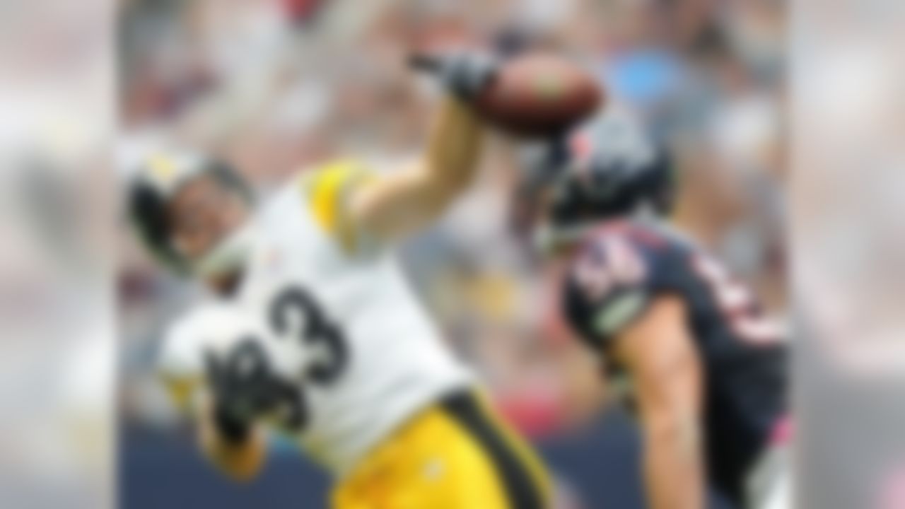 Pittsburgh Steelers tight end Heath Miller catches apass with a little help from the Texans' Brian Cushing during the second quarter Sunday October 2, 2011 at Reliant Stadium in Houston.