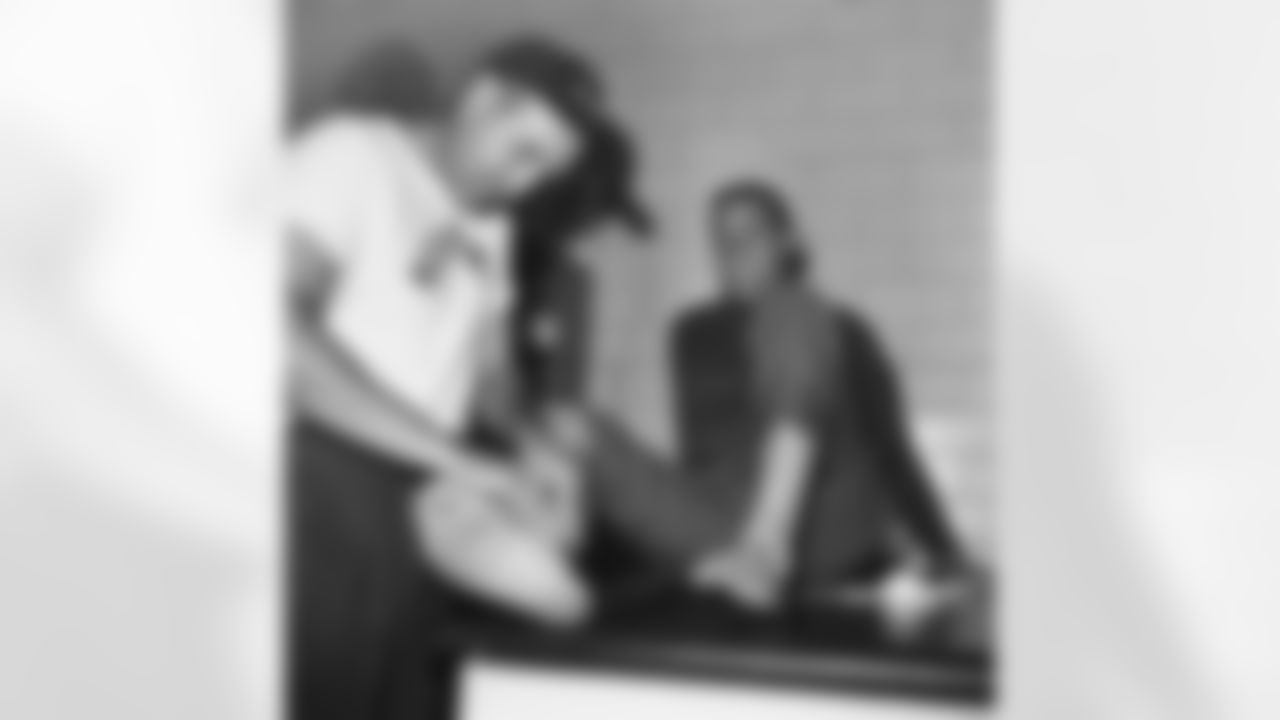 Sam Huff, Washington Redskins middle linebacker, gets his injured right ankle bandaged by trainer Joe Kuczo in Washington on Oct. 25, 1967. Huff who was injured in Sunday's game with the Los Angeles Rams, has a record of never missing a regular season game--the streak totals 157 games including six championship tilts and one playoff game. "I intend to play Sunday," Huff said. The Redskins meet the Baltimore Colts in Washington next Sunday. (AP Photo/Charles Gorry)