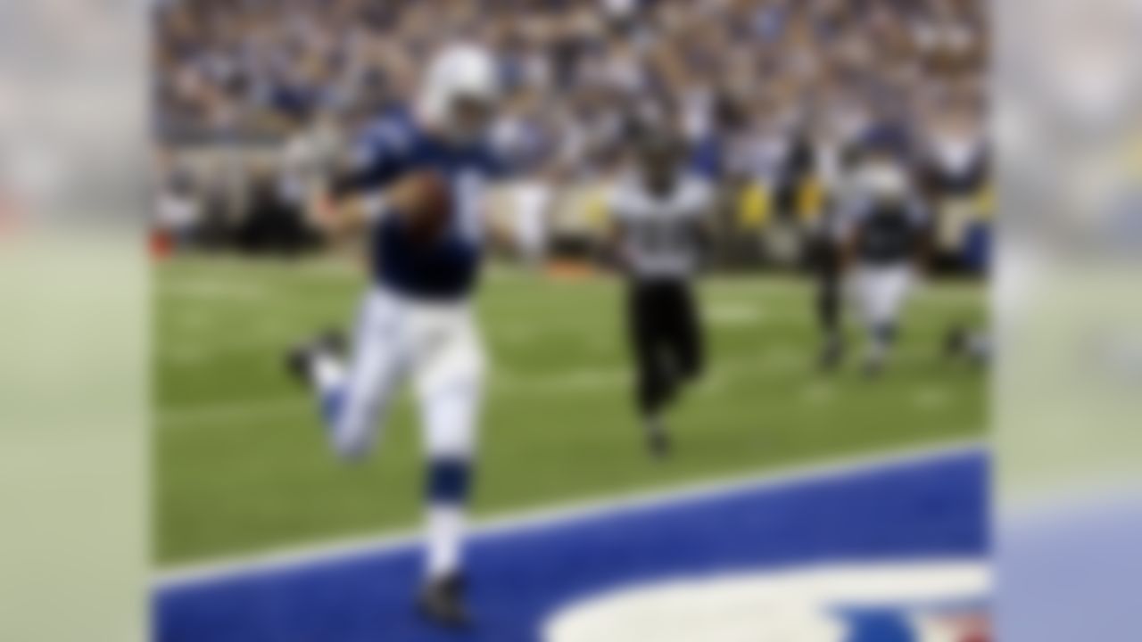 Indianapolis Colts quarterback Peyton Manning scores a touchdown in front of Jacksonville Jaguars safety Donovin Darius in the fourth quarter of NFL football action in Indianapolis on this Sept. 24, 2006. (AP Photo/Michael Conroy)