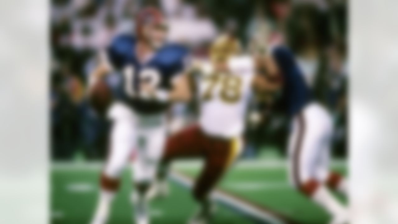 Hall of Fame quarterback Jim Kelly (12) of the Buffalo Bills rolls out to elude defensive pressure during the Bills 37-24 loss to the Washington Redskins in Super Bowl XXVI on January 26, 1992 at the Hubert H. Humphrey Metrodome in Minneapolis, Minnesota. (National Football League)