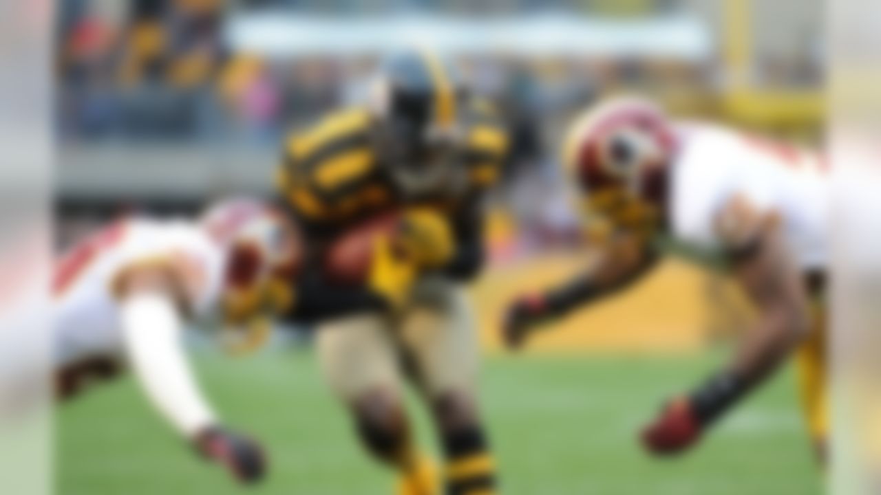 Pittsburgh Steelers wide receiver Mike Wallace (17) is tackled by Washington Redskins defensive back Cedric Griffin (20) and inside linebacker Perry Riley (56) during the first quarter of an NFL football game on Sunday, Oct. 28, 2012, in Pittsburgh. Pittsburgh won 27-12. (AP Photo/Don Wright)