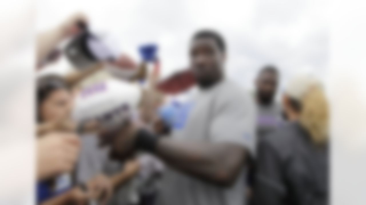 New York Giants defensive end Jason Pierre-Paul is interrupted as he signs autographs at the NFL football team's training camp in Albany, N.Y., Saturday, July 28, 2012. (AP Photo/Kathy Willens)