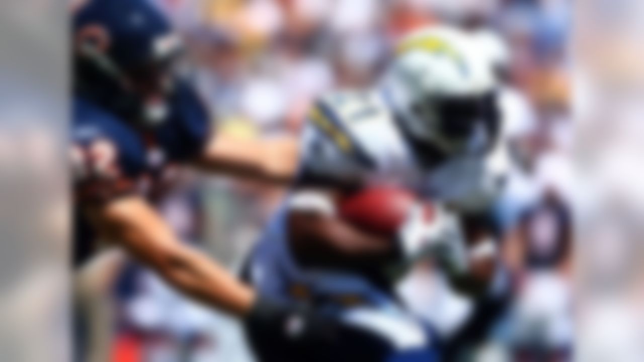 SAN DIEGO, CA - SEPTEMBER 9: Runningback LaDainian Tomlinson #21 of the San Diego Chargers runs with the ball against the tackle of Hunter Hillenmeyer #92 of the Chicago Bears at Qualcomm Stadium September 9, 2007 in San Diego, California. (Photo by Donald Miralle/Getty Images)