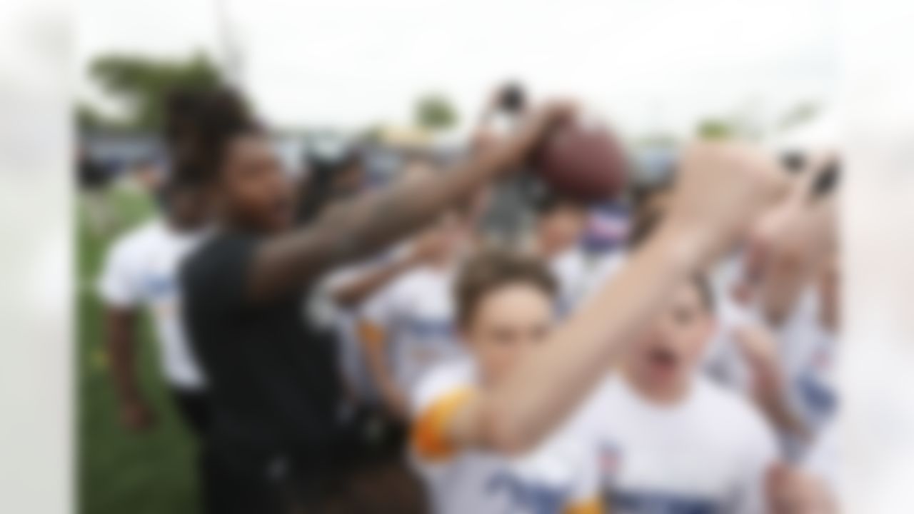 Shaquem Griffin huddles with children at a Play Football event Wednesday, April 25, 2018 in Arlington, Texas.
