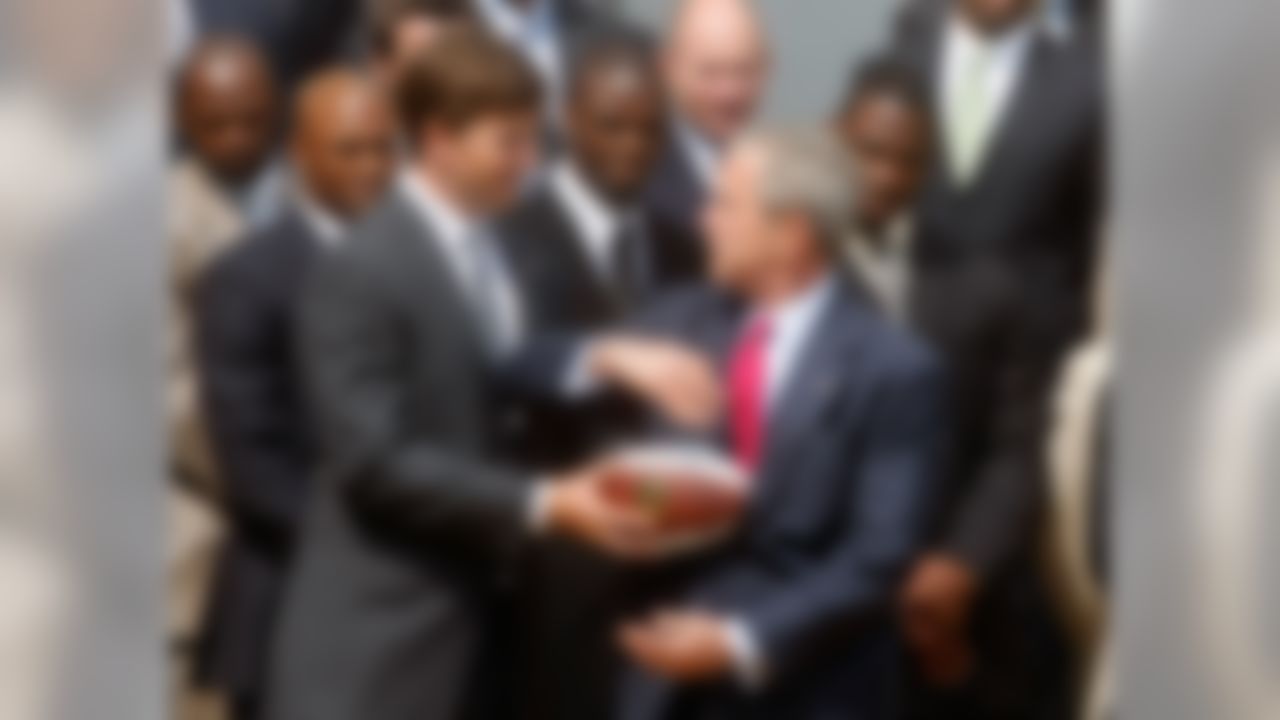 WASHINGTON - APRIL 30: Quarterback Eli Manning hands off a souvenir football to President George W. Bush during a event to honor the Super bowl XLII Champion New York Giants on the south lawn of the White House, April 30, 2008 in Washington, DC. Last February the Giants beat the New England Patriots 17 to 14, in one of the biggest upsets in Super Bowl history. (Photo by Mark Wilson/Getty Images)