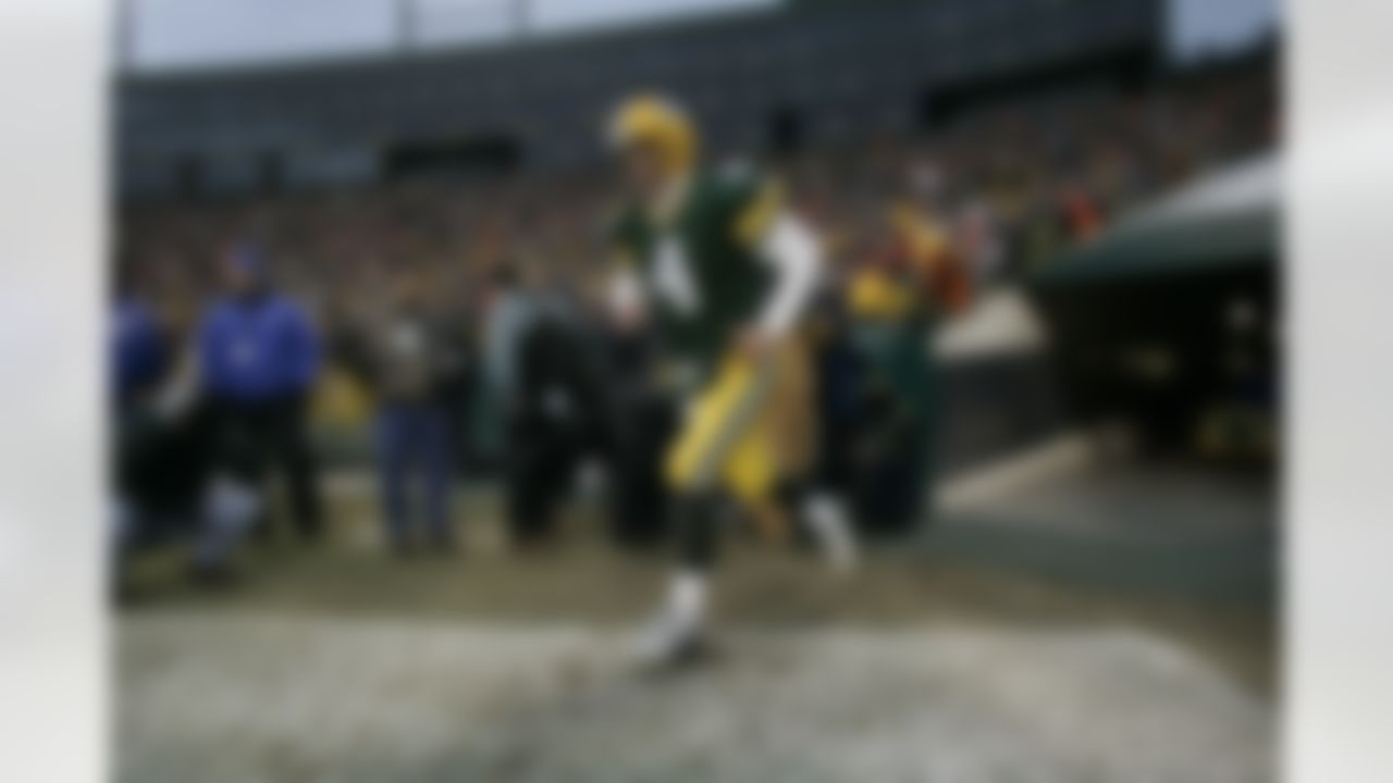 Quarterback Brett Favre #4 of the Green Bay Packers runs on the field during introductions against the Detroit Lions at Lambeau Field on December 12, 2004 in Green Bay, Wisconsin. (AP Photo/Scott Boehm)