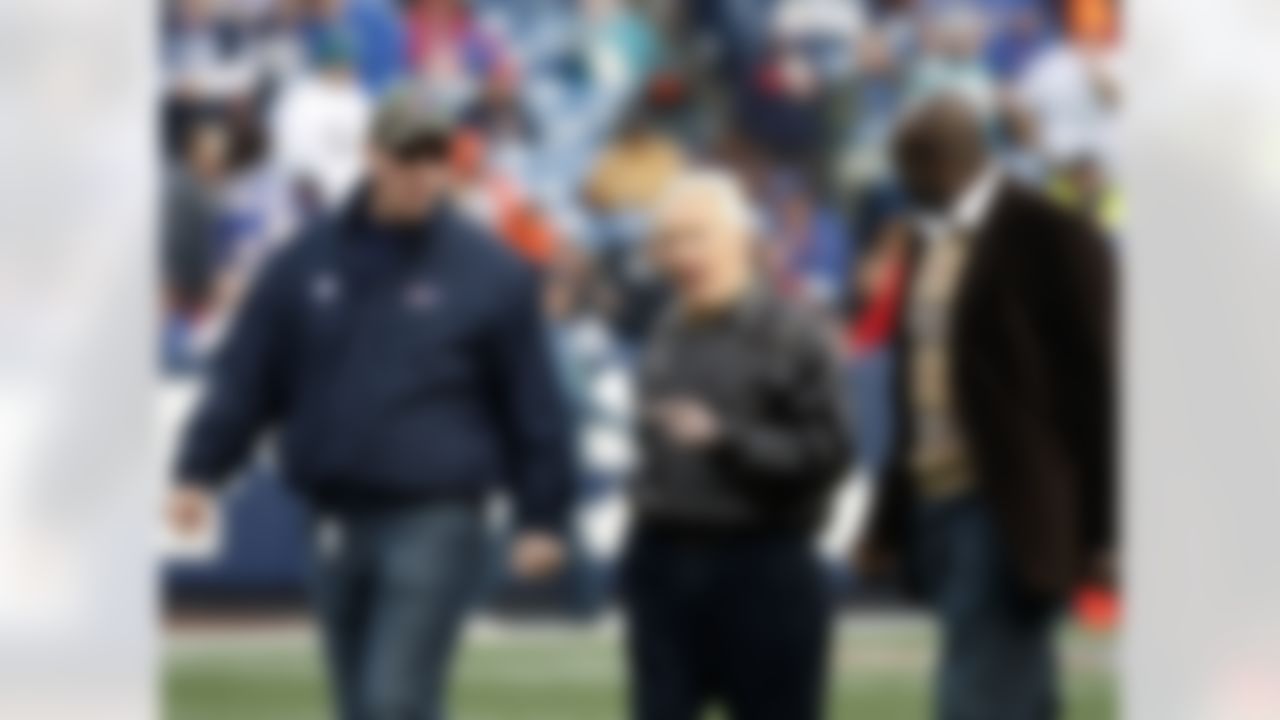 Former Buffalo Bills coach Marv Levy walks with Jim Kelly, left, and Bruce Smith, right, to a Hall of Fame ring ceremony for Smith during halftime against the Miami Dolphins in Orchard Park, N.Y, Sunday Nov. 29, 2009. (AP Photo/ Dean Duprey)