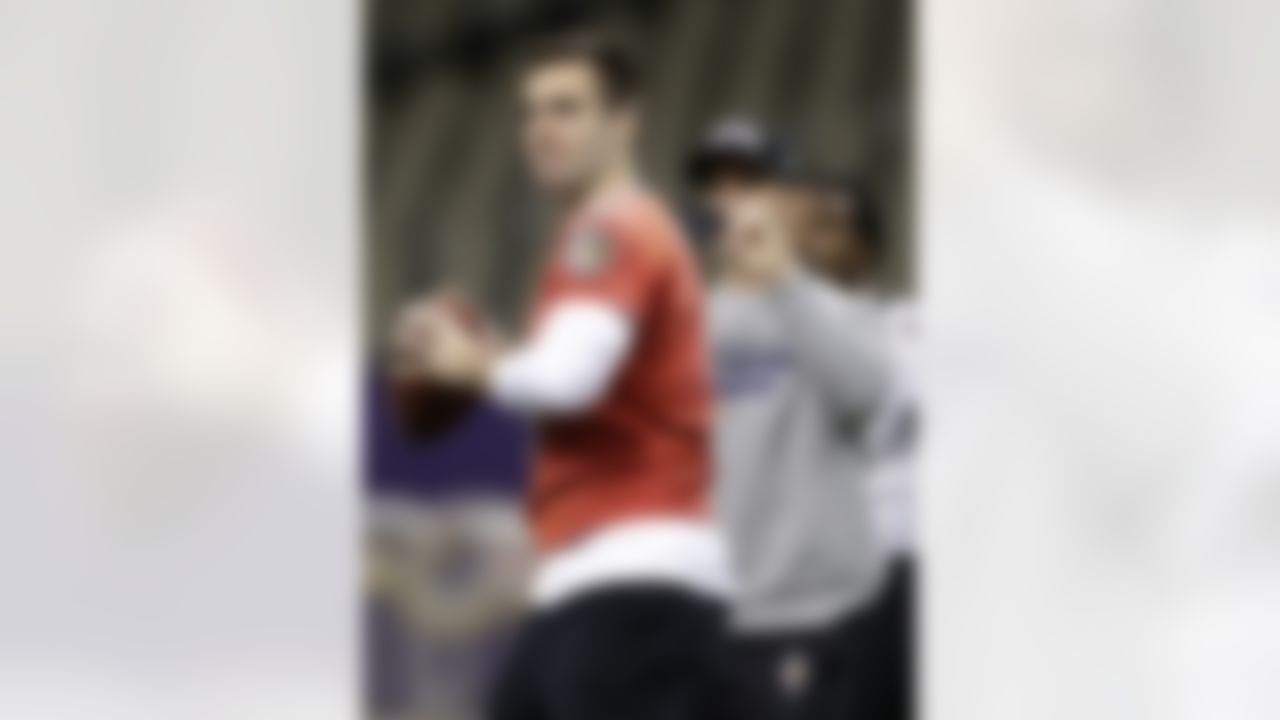 Baltimore Ravens quarterback Joe Flacco, front, prepares to throw a pass as head coach John Harbaugh snaps a picture on his cell phone during an NFL Super Bowl XLVII walkthrough on Saturday, Feb. 2, 2013, in the Mercedes-Benz Superdome in New Orleans. The Ravens face the San Francisco 49ers in Super Bowl XLVII on Sunday. (AP Photo/Patrick Semansky)