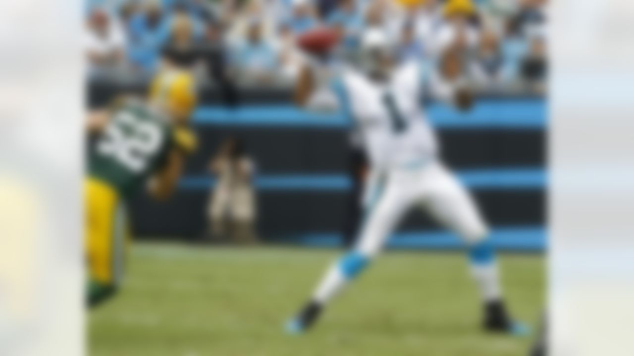 Carolina Panthers' Cam Newton (1) throws a pass under pressure from Green Bay Packers' Clay Matthews (52) during the first quarter of an NFL football game in Charlotte, N.C., Sunday, Sept. 18, 2011. (AP Photo/Chuck Burton)