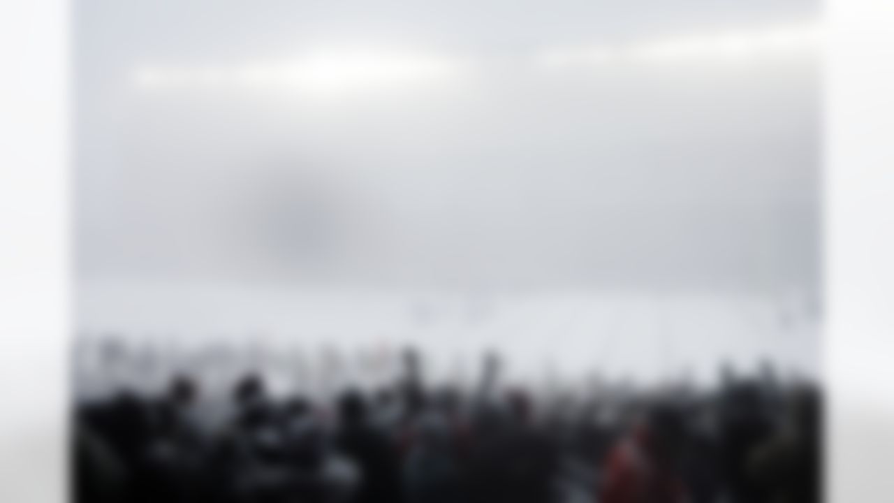 Fans watch the first half of an NFL football game between the Philadelphia Eagles and the Detroit Lions as snow falls, Sunday, Dec. 8, 2013, in Philadelphia. (AP Photo/Matt Rourke)