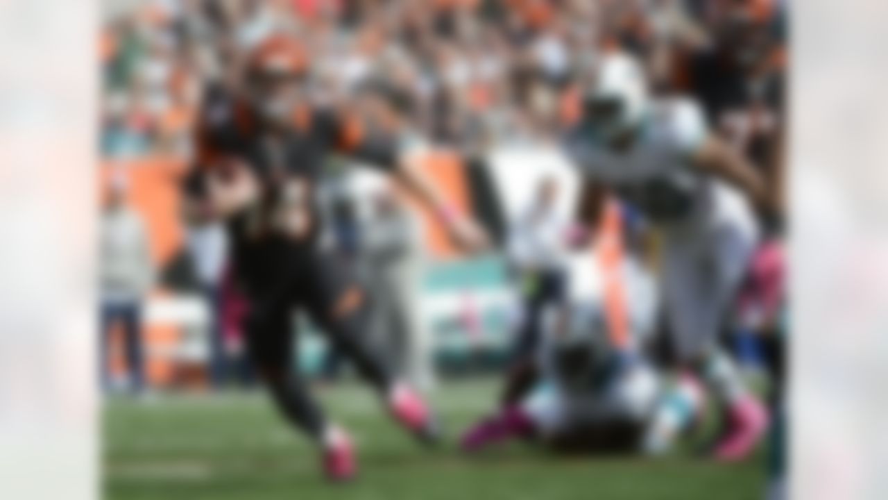 Cincinnati Bengals quarterback Andy Dalton (14) runs against the Miami Dolphins in the second half of an NFL football game, Sunday, Oct. 7, 2012, in Cincinnati. (AP Photo/Michael Keating)