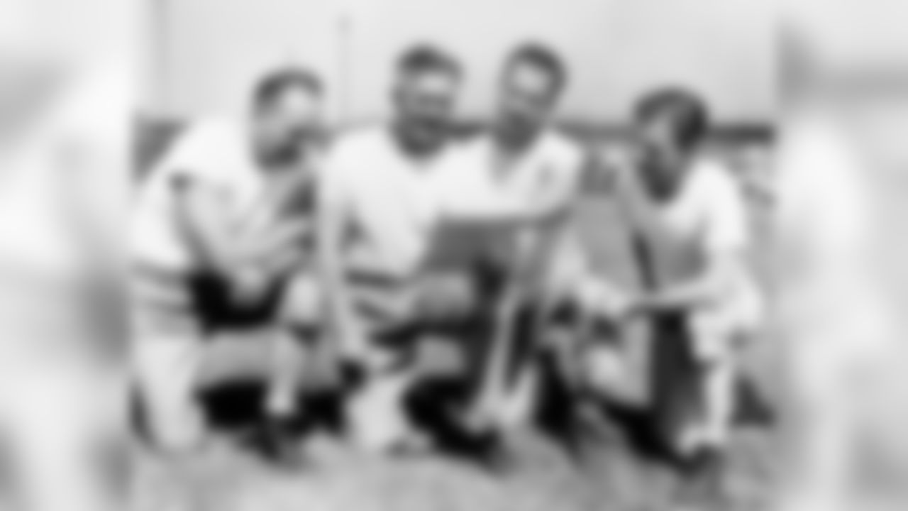 Coach E. L. (Curly) Lambeau (second from left) and his staff plan a campaign for the Green Bay Packers at Green Bay, Wisconsin, on August 10, 1945 during the first workout. Coach Walt Kiesling, Lambeau, assistant coach Don Hutson, and Eddie Kotal, scout and assistant. (Associated Press)