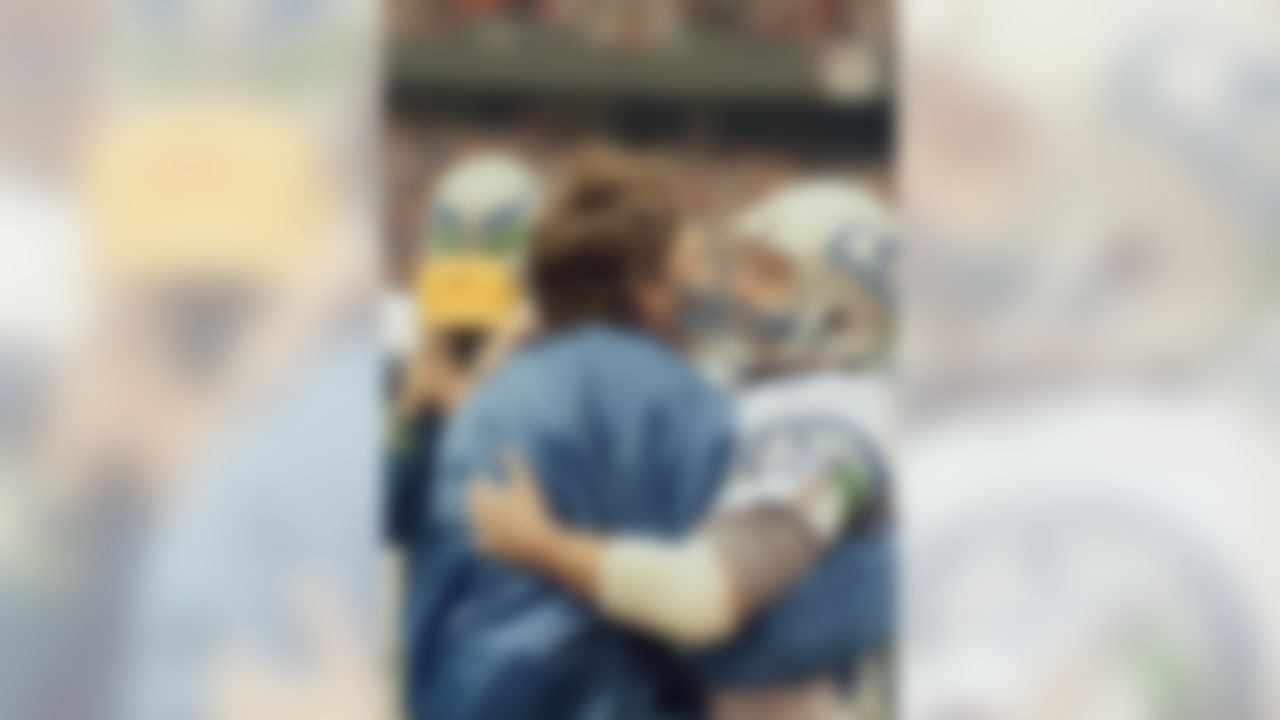 Seattle Seahawks receiver Steve Largent (80) hugs quarterback Dave Krieg on the sidelines at Riverfront Stadium in Cincinnati during their game with the Cincinnati Bengals, Dec. 11, 1989. Largent had just caught his 100th career touchdown pass, thrown by Krieg, to break the 44-year-old NFL record he shared with Don Hutson. (AP Photo/Rob Burns)