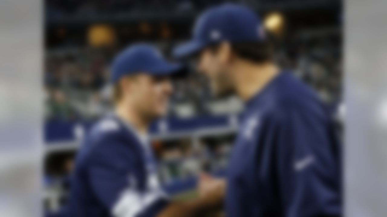 Golfer Jordan Spieth, left, talks with Dallas Cowboys quarterback Tony Romo before the Cowboys' NFL football game against the New York Jets on Saturday, Dec. 19, 2015, in Arlington, Texas. (AP Photo/Brandon Wade)