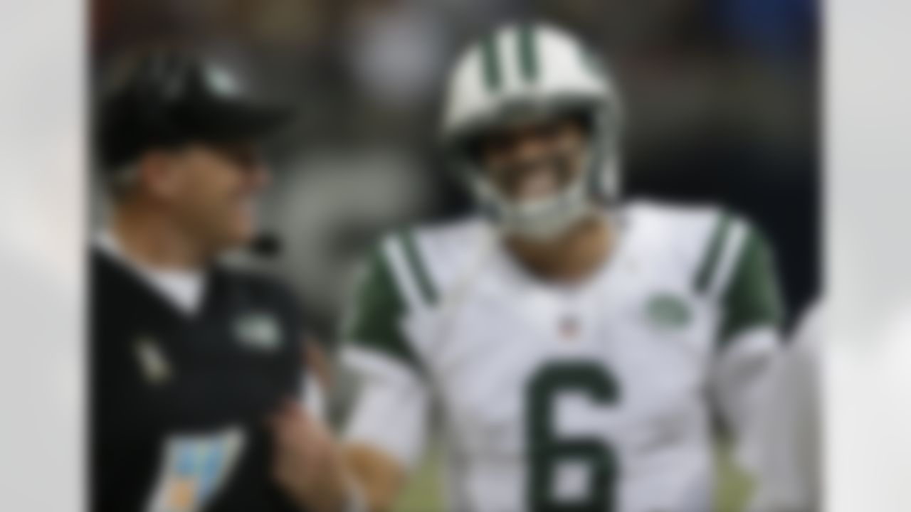 New York Jets quarterback Mark Sanchez, right, smiles as he talks with head coach Rex Ryan after a touchdown by running back Bilal Powell during the fourth quarter of an NFL football game against the St. Louis Rams Sunday, Nov. 18, 2012, in St. Louis. (AP Photo/Tom Gannam)