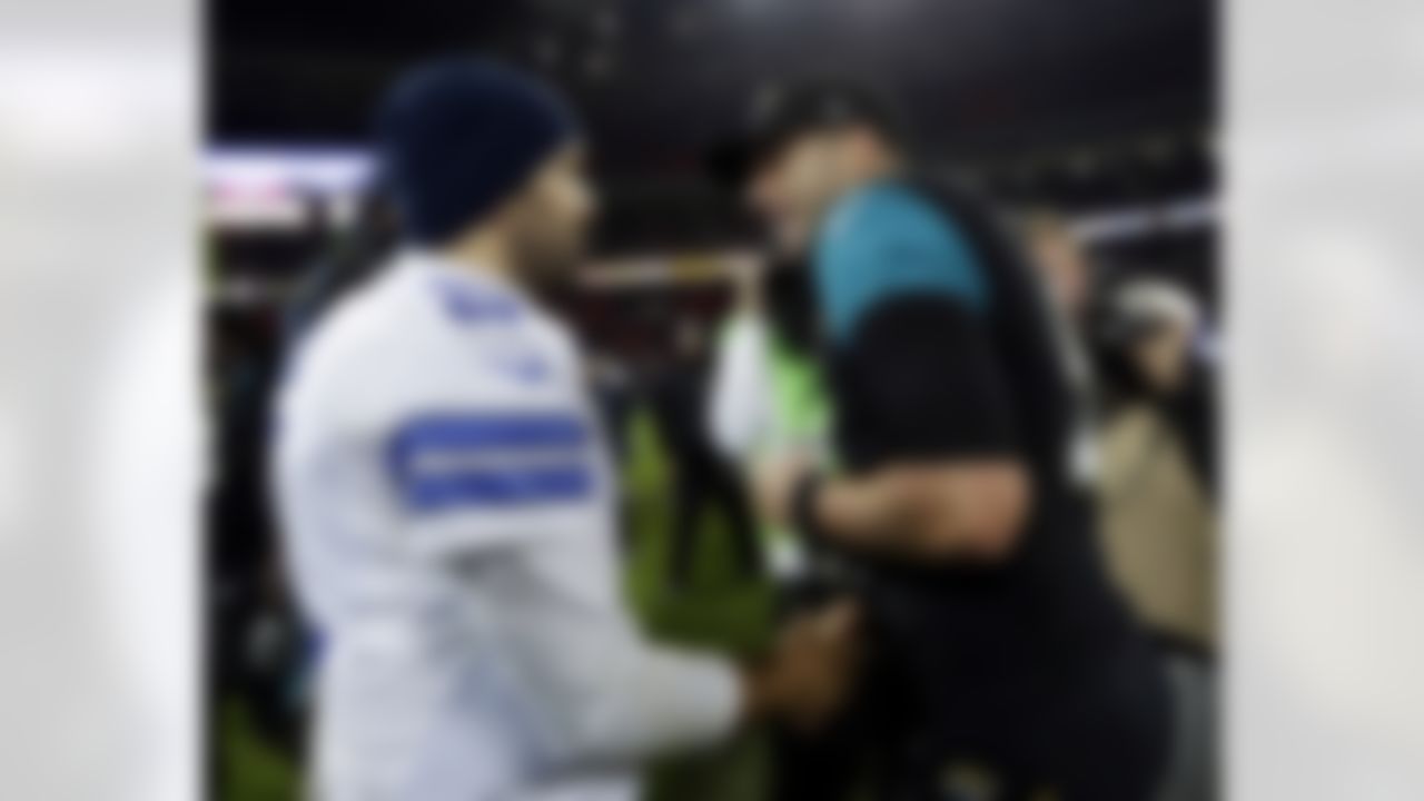 Dallas Cowboys quarterback Tony Romo, left, shakes hands with Jacksonville Jaguars quarterback Blake Bortles following their NFL football game at Wembley Stadium, London, Sunday, Nov. 9, 2014. The Cowboys defeated the Jaguars 31-17. (AP Photo/Matt Dunham)