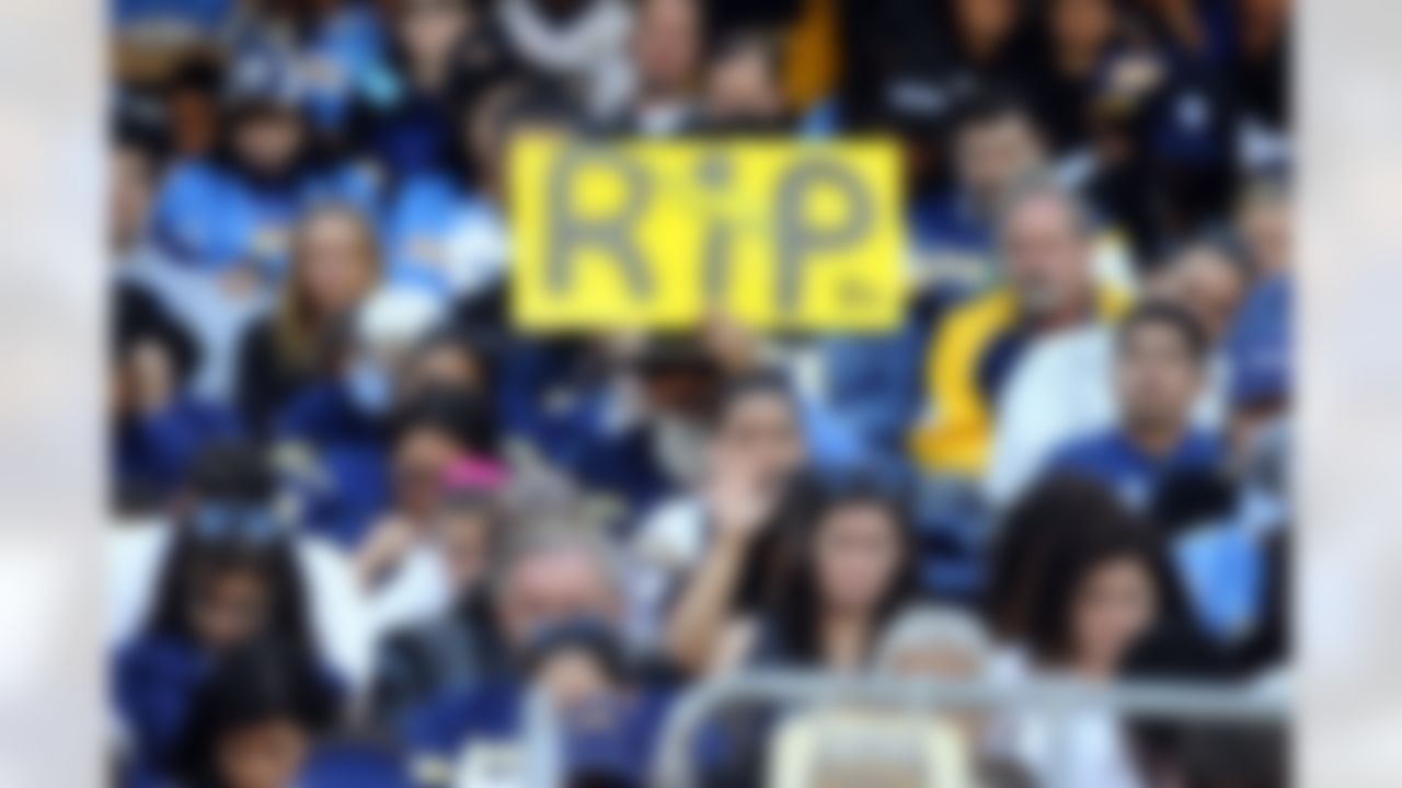 May 11, 2012; San Diego, CA, USA; A San Diego Chargers fan holds a sign during a celebration of life service to remember Junior Seau at Qualcomm Stadium. Mandatory Credit: Christopher Hanewinckel-US PRESSWIRE