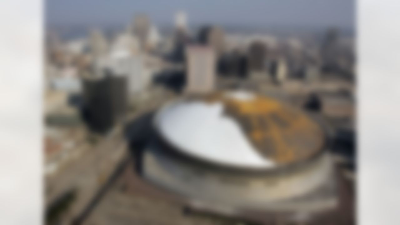 The damaged roof of the Superdome is set against the downtown skyline in New Orleans on Friday, Oct. 14, 2005. (AP Photo/Don Ryan)