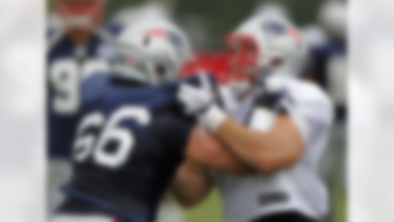 New England Patriots defensive end Jake Bequette (66), left, Patriots linebacker Mike Rivera (47), right, grapple during a drill at an NFL football training camp in Foxborough, Mass., Sunday, July 29, 2012. (AP Photo/Steven Senne)