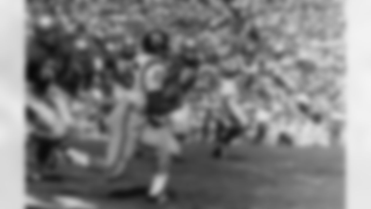 Mel West, (26), Missouri halfback breaks away from would be Georgia tacklers for a good gain in the first quarter of the Orange Bowl game in Miami Jan. 1, 1960. Bill Brinkman (78) Missouri tackle is at right. Georgia players are: Pat Dye, (60), guard: guard Billy Roland, (68), guard. (Associated Press)
