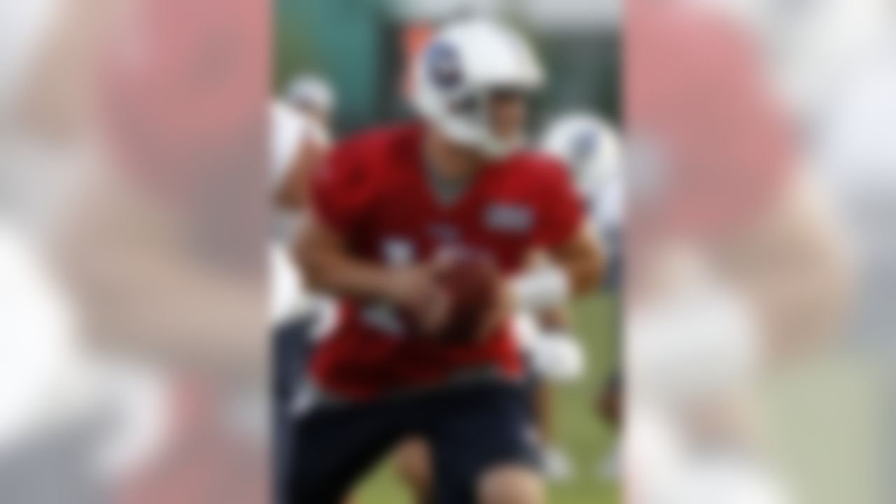 Tennessee Titans quarterback Jake Locker turns to hand the ball off during NFL football camp at Titans' headquarters Sunday, July 29, 2012 Nashville, Tenn. (AP Photo/Wade Payne)