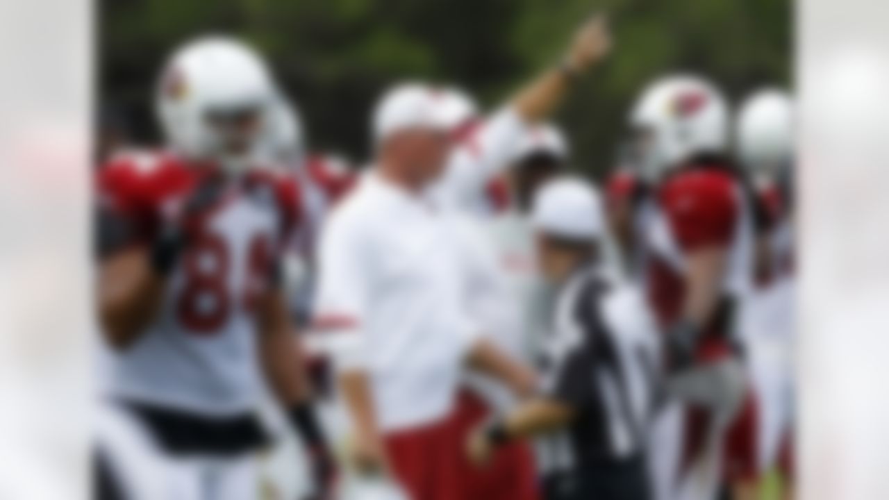 Arizona Cardinals head coach Ken Whisenhunt, center, shouts instructions as Rob Housler (84) and Larry Fitzgerald, right, get ready for a play to be called during NFL training camp football practice at Northern Arizona University, Saturday, July 28, 2012, in Flagstaff, Ariz. (AP Photo/Ross D. Franklin)