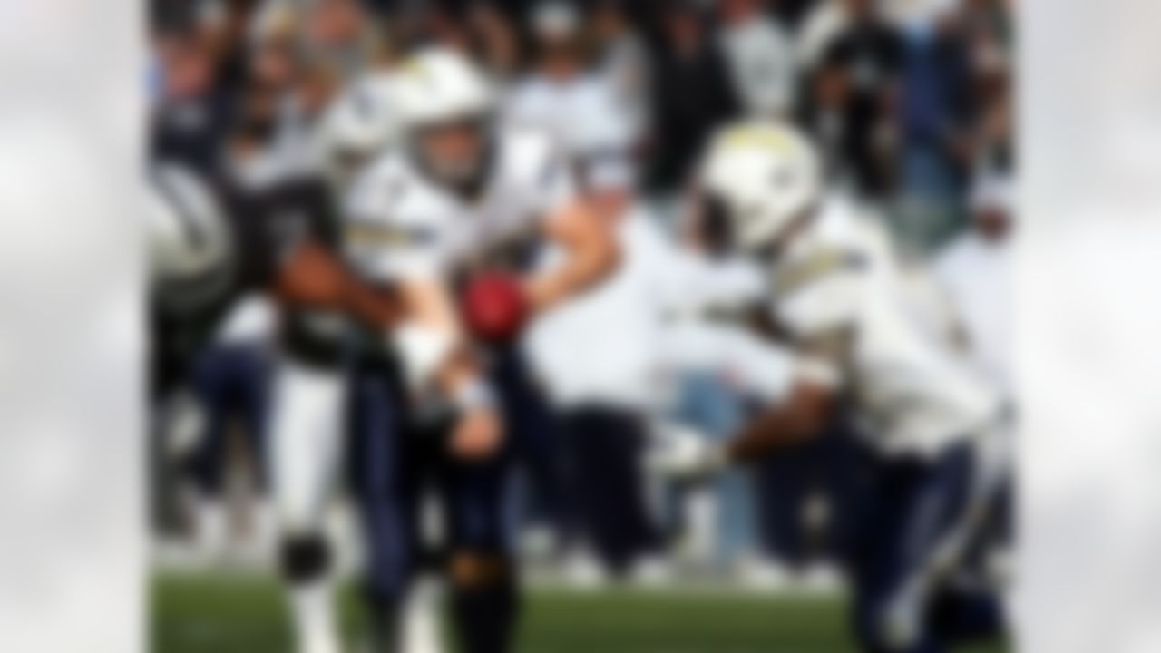Dec 30, 2007; Oakland, CA, USA; Oakland Raiders defensive tackle Warren Sapp (99) knocks the ball away from San Diego Chargers quarterback Philip Rivers (17) while attempting to hand the ball off to running back LaDainian Tomlinson (21) during the first quarter at McAfee Coliseum in Oakland, CA. Mandatory Credit: Phil Carter-US PRESSWIRE