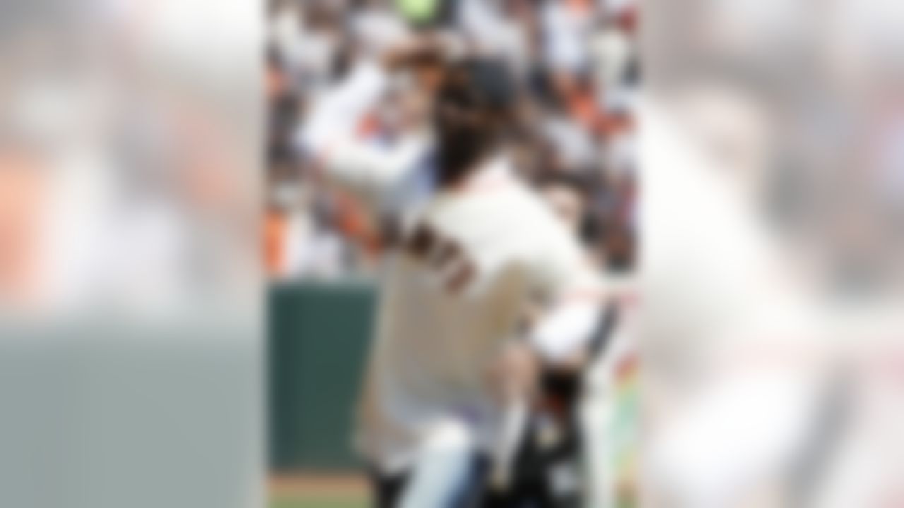 San Francisco 49ers Hall-of-Famer Jerry Rice throws out the ceremonial first pitch before the San Francisco Giants baseball game against the Atlanta Braves in San Francisco, Friday, April 9, 2010. (AP Photo/Eric Risberg)