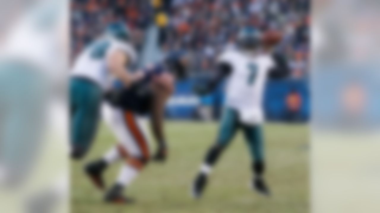 Philadelphia Eagles quarterback Michael Vick, right, throws under pressure by Chicago Bears defensive tackle Anthony Adams in the first half of an NFL football game in Chicago, Sunday, Nov. 28, 2010. (AP Photo/Charles Rex Arbogast)