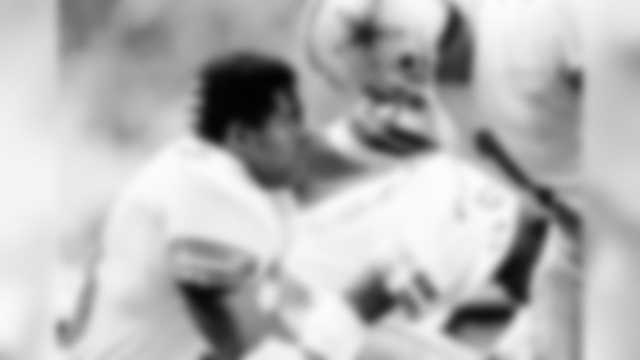 Dallas Cowboys placekicker Rafael Septien, right, pats teammate Tony Dorsett on the head after his record setting 99 1/2 yard touchdown run in the fourth quarter of a game against the Minnesota Vikings in Minneapolis on Jan. 4, 1983. The Vikings won 31-27. (AP Photo/Jim Mone)