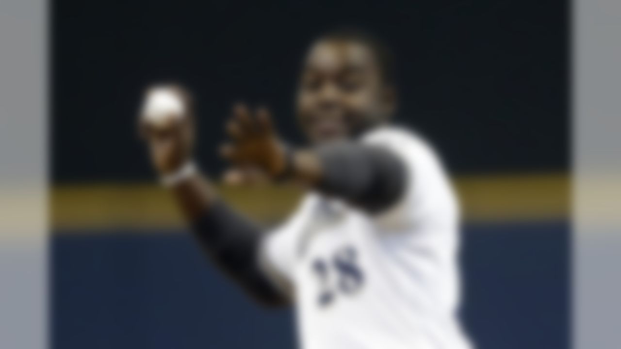 Former Wisconsin running back Montee Ball throws out the ceremonial first pitch before a baseball game between the Milwaukee Brewers and the San Francisco Giants Thursday, April 18, 2013, in Milwaukee. (AP Photo/Morry Gash)