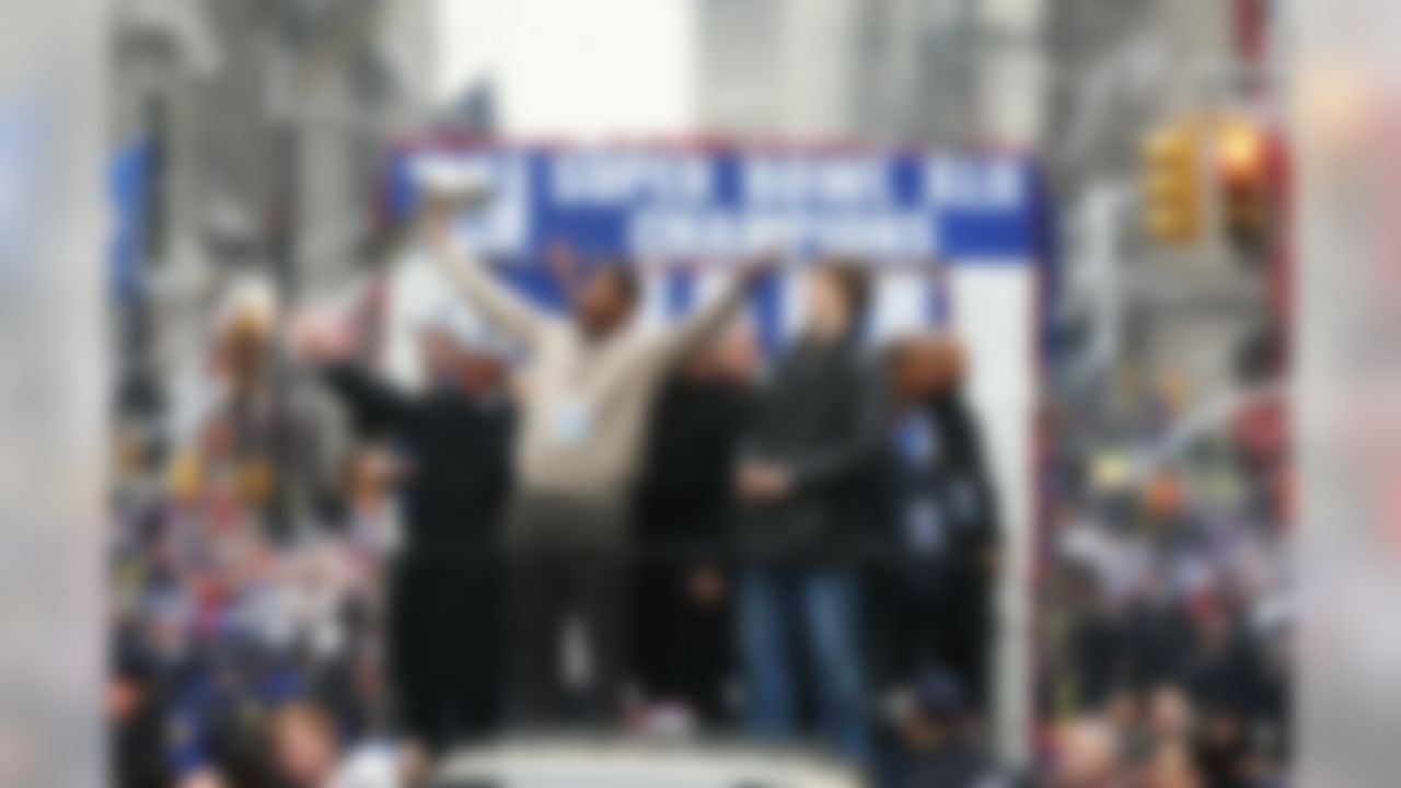 NEW YORK - FEBRUARY 05: Mayor of New York Michael Bloomberg (L), Michael Strahan (C) and Eli Manning of the New York Giants ride in a float along Broadway, also known as "The Canyon of Heroes" during Super Bowl XLII victory parade in New York City, New York. (Photo by Al Bello/Getty Images)