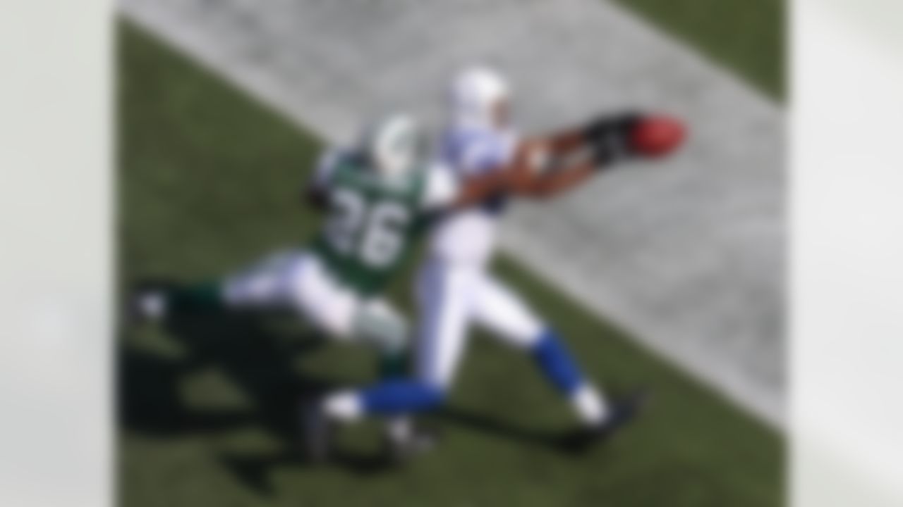 Safety Eric Coleman #26 of the New York Jets attempts to knock the ball away from wide receiver Marvin Harrison #88 of the Indianapolis Colts at the Meadowlands on October 1, 2006 in East Rutherford, New Jersey. (AP Photo/David Drapkin)