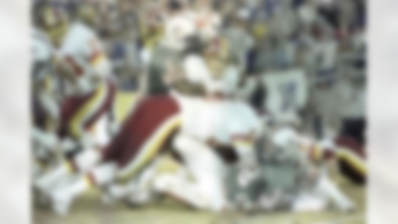 Washington Redkins running back John Riggins is gang tackled by a group of Miami Dolphins as he tries to pick up yardage during the Super Bowl XVII in Pasadena, CA on January 30, 1983. (Associated Press)