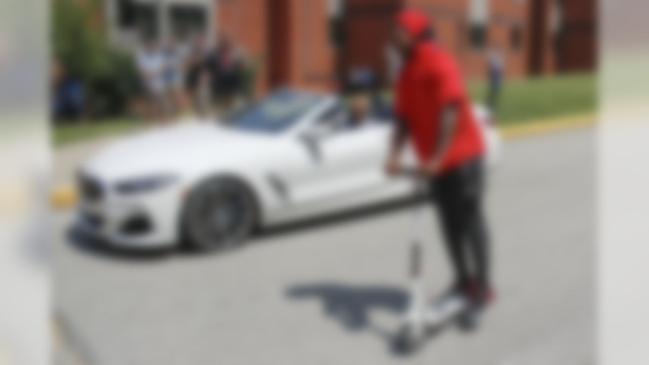 Pittsburgh Steelers outside linebacker Bud Dupree, right, talks with fullback Roosevelt Nix-Jones (45) as he rides by on his electric scooter as the team arrives for NFL football training camp in Latrobe, Pa., Thursday, July 25, 2019.