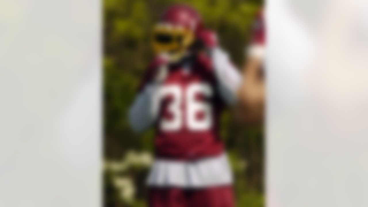 Safety Sean Taylor, a Washington Redskins first-round draft pick, attaches his chinstrap during minicamp Friday, April 30, 2004, in Ashburn, Va. (AP Photo/Nick Wass)