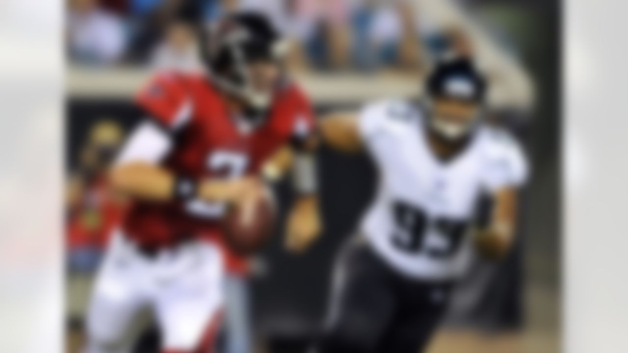 Atlanta Falcons quarterback Matt Ryan (2) scrambles for yardage against Jacksonville Jaguars defensive tackle Tyson Alualu (93) during the first half of an NFL preseason football game in Jacksonville, Fla., Friday, Aug. 19, 2011. (AP Photo/Stephen Morton)