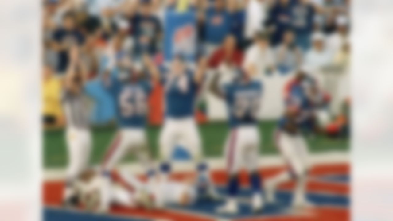 New York Giants defense Lawrence Taylor (56), Erik Howard (74) and Leonard Marshall (70) celebrate over Denver broncos quarterback John Elway after he was sacked by George Martin (75) for safety in the second quarter of Super Bowl XXI in Pasadena, Calif. (AP Photo/Ron Heflin)