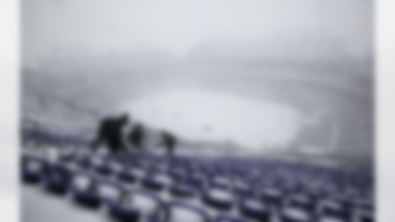 Workers remove snow from the stands at M&T Bank Stadium during a winter storm, Saturday, Dec. 19, 2009, in Baltimore. The Baltimore Ravens will host the Chicago Bears in an NFL football on Sunday. A blizzard-like storm rocked the Mid-Atlantic and Northeast on Saturday, crippling travel across the region and causing tens of thousands of power outages. (AP Photo/Rob Carr)
