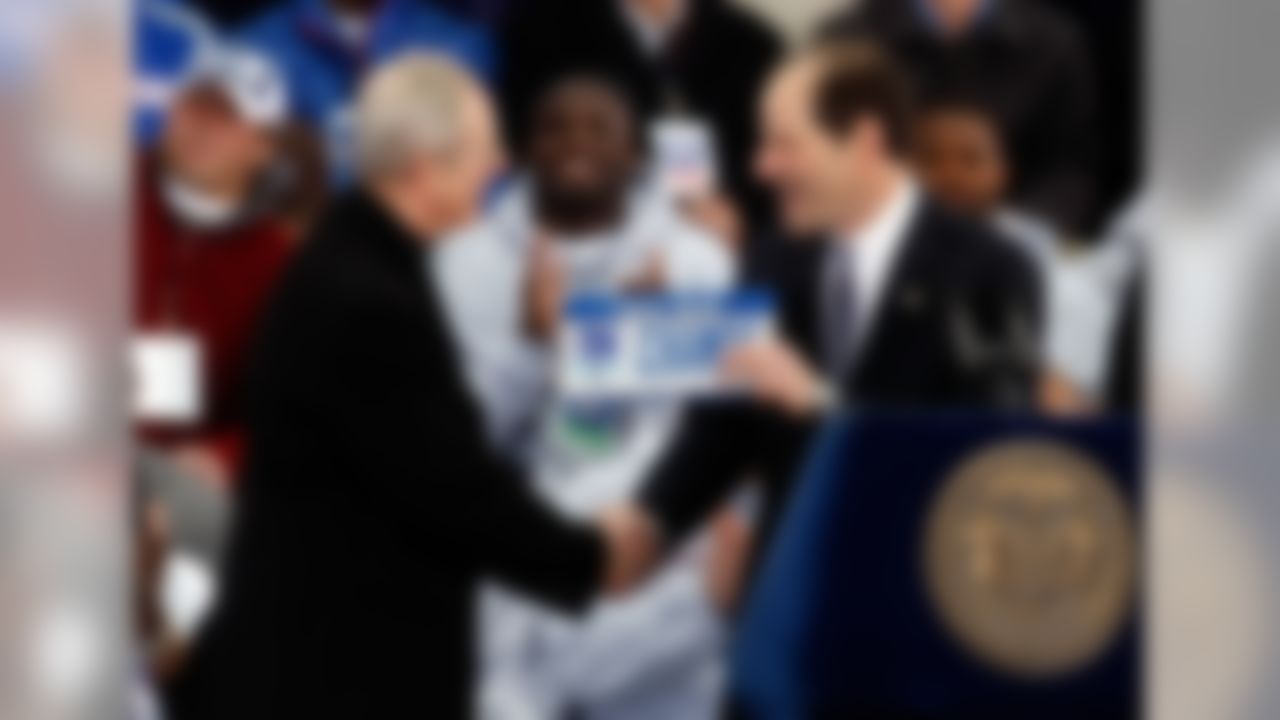 NEW YORK - FEBRUARY 05: Head coach Tom Coughlin is given a license plate by New York Governor Eliot Spitzer during the New York Giants Super Bowl XLII victory parade reception at City Hall February 5, 2008 in New York City. (Photo by Nick Laham/Getty Images)