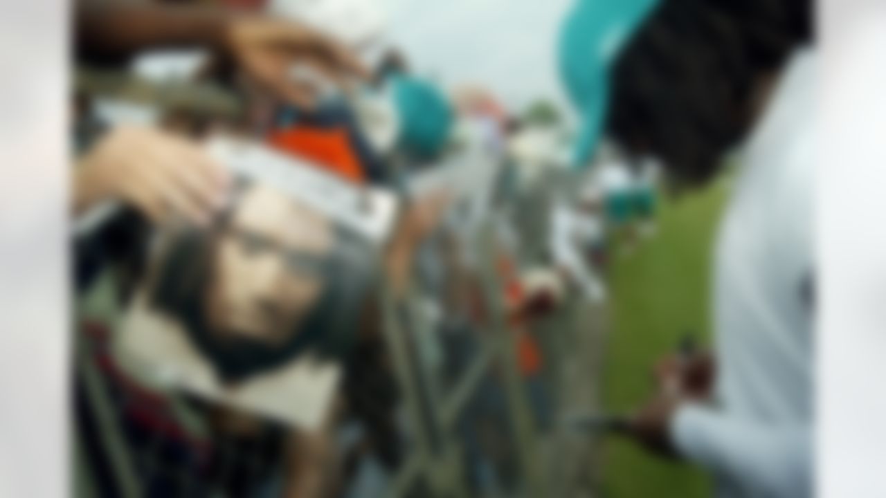 Miami Dolphins running back Ricky Williams signs autographs after afternoon practice at the Dolphins training facility in Davie, Fla., on Wednesday, July 30, 2003. (AP Photo/Richard Patterson)