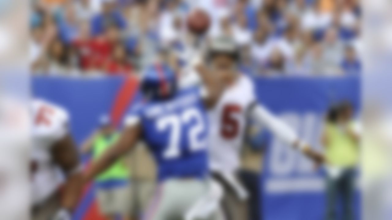 Tampa Bay Buccaneers quarterback Josh Freeman passes over New York Giants defensive end Osi Umenyiora. (AP Photo/Bill Kostroun)