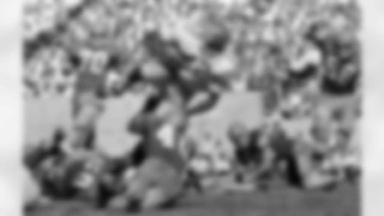 Ohio State back Paul Warfield (42) barrels along in the third quarter in Bloomington, Ind., on 5, 1963, into the waiting arms of Indiana's back Marvin Woodson (40). Warfield gained about 5 yards on the play. Ohio State won, 21-0. (AP Photo/RD)