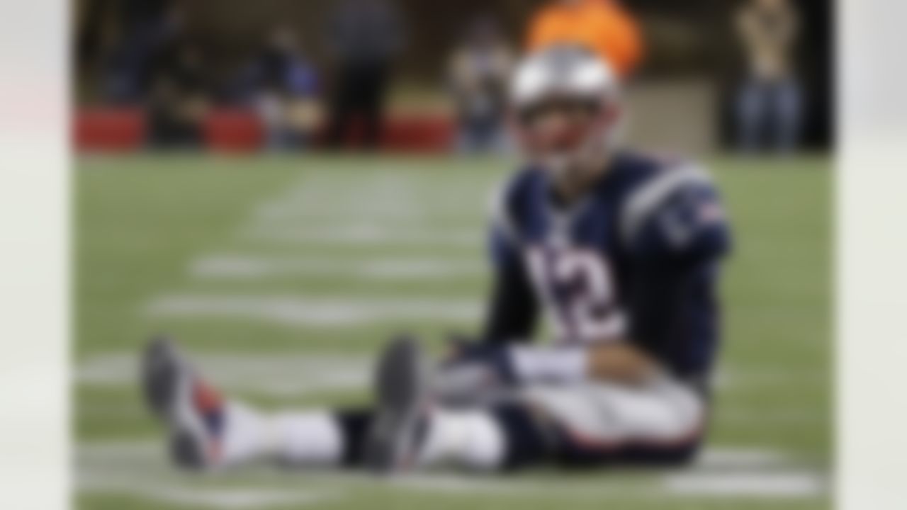 Tom Brady sits on the field after getting hit during the New England Patriots' loss to the Baltimore Ravens in the AFC Championship Game. (AP Photo/Steven Senne)