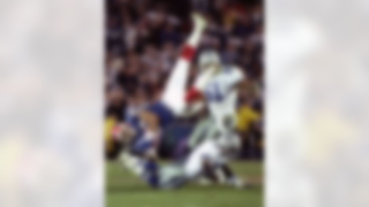 FILE - In this Jan. 31, 1993 file photo, Buffalo Bills' wide receiver Andre Reed is upended by Dallas Cowboys' strong safety Thomas Everett after a 13-yard reception in the third quarter of the Super Bowl in Pasadena, Calif. Reed was elected to the Pro Football Hall of Fame on Saturday, Feb. 1, 2014. (Doug Mills/Associated Press)